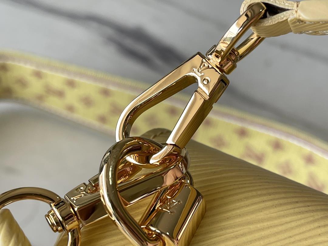 M22036 yellowThis Twist medium size handbag is paired with embroidered fabric shoulder straps