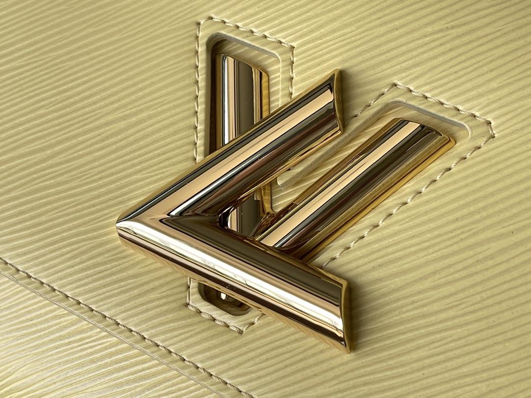 M22036 yellowThis Twist medium size handbag is paired with embroidered fabric shoulder straps