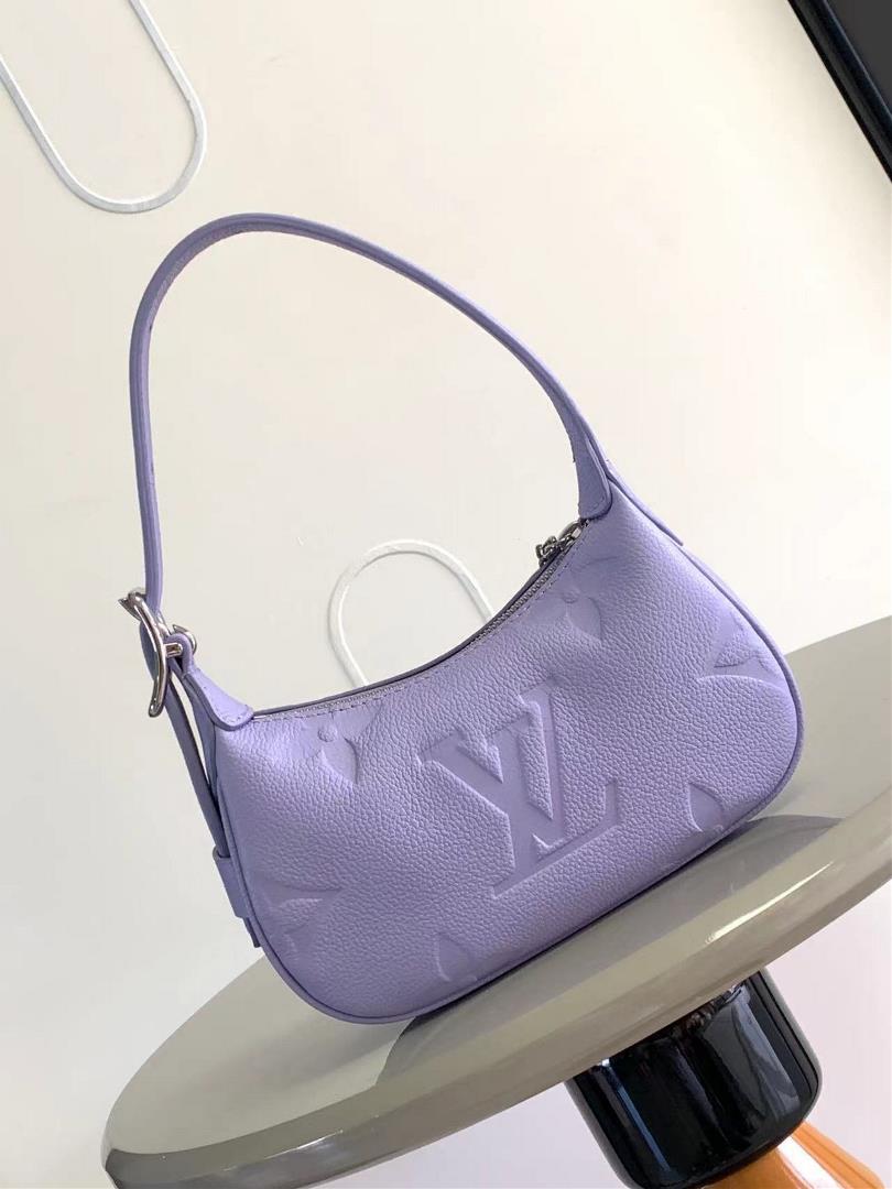 The M82391 M82519 Mini Moon handbag is made of soft Monogram Imprente embossed leather al
